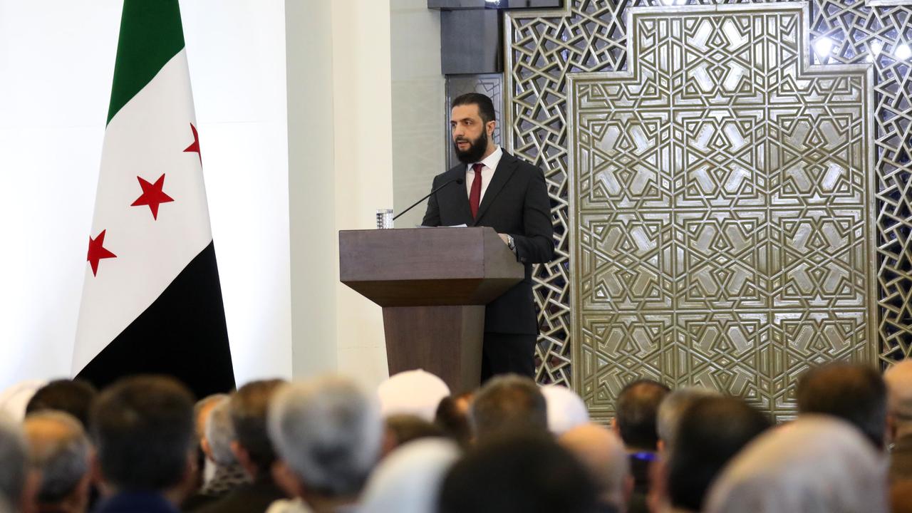 Der syrische Präsident Ahmed al-Sharaa hält eine Rede auf der Nationalen Dialogkonferenz am 25. Februar 2025 in Damaskus, Syrien. Er steht an einem Pult. Im Vordergrund ist das Publikum zu sehen.