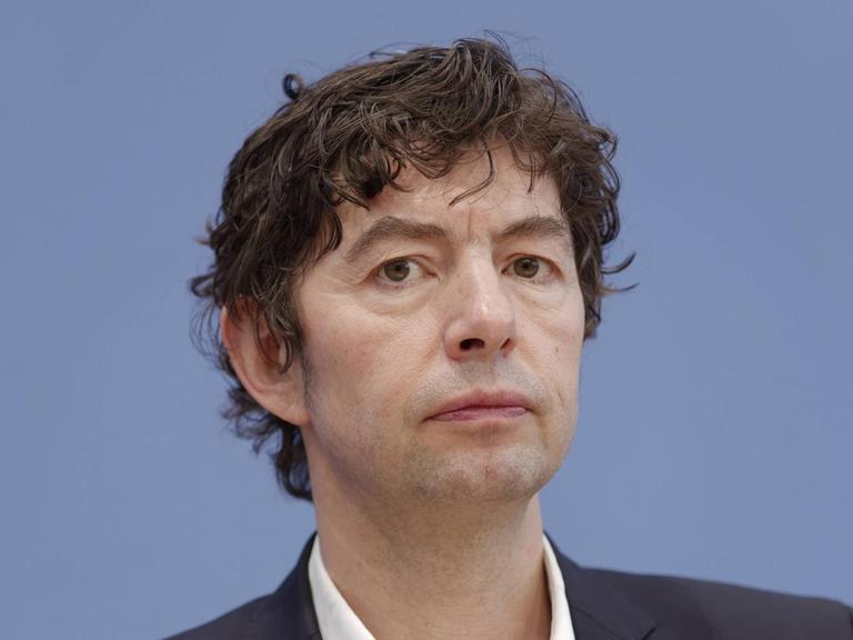 Christian Drosten, Direktor des Instituts für Virologie der Charite Berlin, sitzt auf dem Podium bei der Bundespressekonferenz.